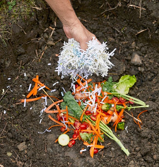 Adding layers of wet and dry material such as shredded papar, dried leaves, cow manure, kitchen scraps and prunings helps the composting process